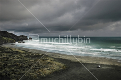 A storm approaches deserted Bethells Beach near Auckland, West Coast, North Island, New Zealand