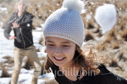 Action shot - girl evades a snowball (motion blur)