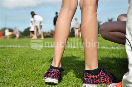 Spectators at a girl's cricket match selective focus)