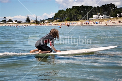Young girl learning to surf at Whangamata (see also Images #100468_554 and #100468_598)