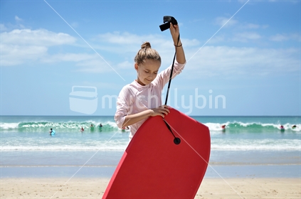 A girl prepares to boogie board