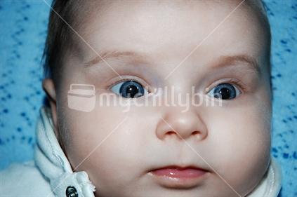 Close up of a baby looking surprised or bewildered