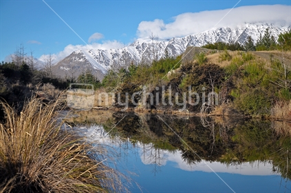 The Remarkables reflected in a hill top lake (see also Image #mychillybin100468_994)