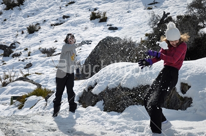Mum and daughter snowball fight (selective focus and some motion blur)