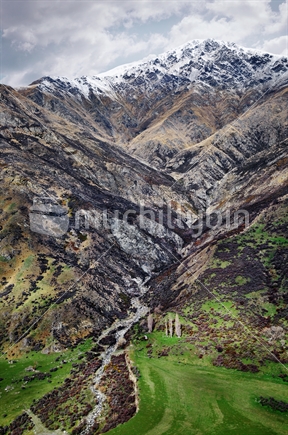 A river valley is cut from the slopes of Mount Ben Cruachan, The Remarkables, Queenstown, South Island, New Zealand