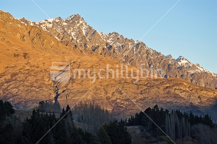 The Remarkables glow orange at sunset