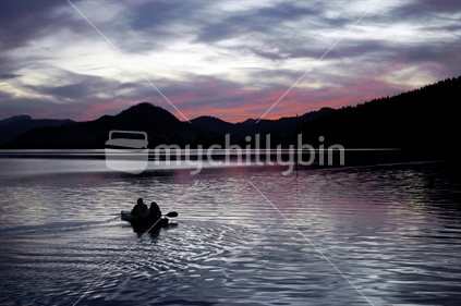 Father and daughter go night fishing in a kayak on the estuary at Opoutere, Coromandel