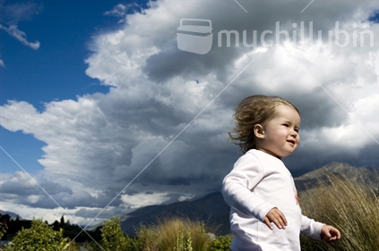 A little girl struggles to walk into a Southerly gale
