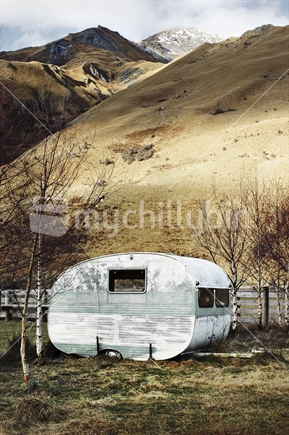 Old weather beaten caravan on high country farm