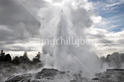 A geyser erupts at dusk, Rotorua, North Island, New Zealand