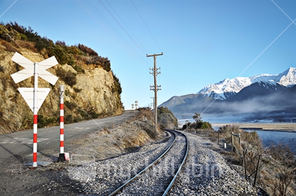 A road crossing over the TranzAlpine railway, next to the Waimakariri River near Arthur''s Pass, South Island, New Zealand 