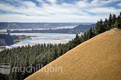 A view down the Rakaia River looking over dry paddocks and pine forest, Canterbury, South Island