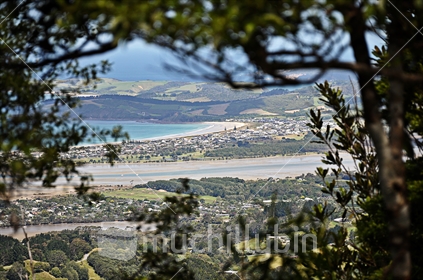 Omaha Beach and Point Wells viewed through the bush, from Mount Tamahunga