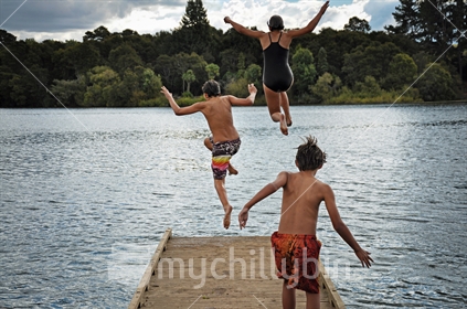 Three kids jumping off a jetty, at Lake Arapuni, South Waikato (same kids as in image #100468_320)