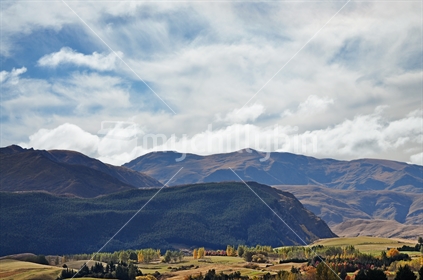 Vista of the hills behind Arrowtown with Autumn rural foreground (selective focus)