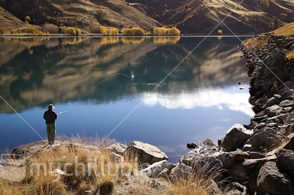Fly fishing in Lake Dunstan behind the Clyde dam (slight motion blur)