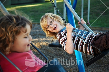 Two kids on swings (selective focus and some Motion Blur)