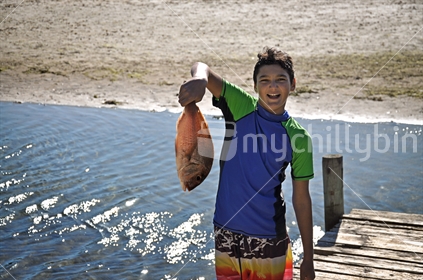 Boy holds a Snapper (selective focus)