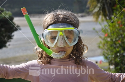 Girl wearing a scuba mask and snorkel takes a timer self portrait