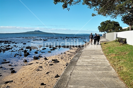 A family walk between Milford and Takapuna on Auckland's North Shore (selective focus on family)