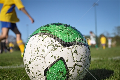 Close-up of a football with game in the background (selective focus)