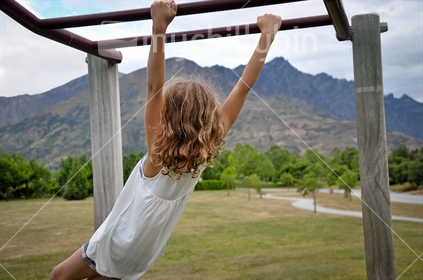 Girl on the monkey bars in Queenstown (selective focus and some motion blur)