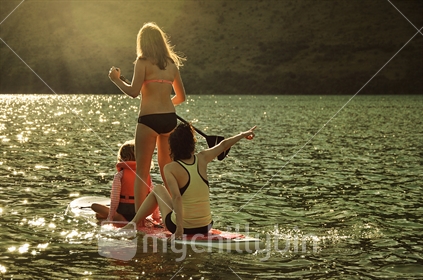 Family Snap / Golden Light: A family paddle-board at dusk on Moke Lake near Queenstown