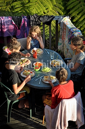 Kids eat dinner on the deck (see also Image #100468_757, #100468_813 and Image #100468_812) 