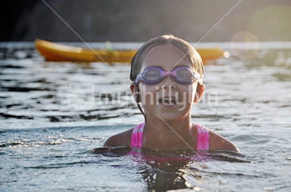 Happy girl swims at dusk (some motion blur and low light noise)