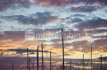 Boat masts at sunset