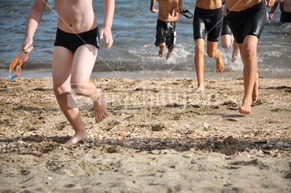 Kids leave the water after the swim in a Triathlon 