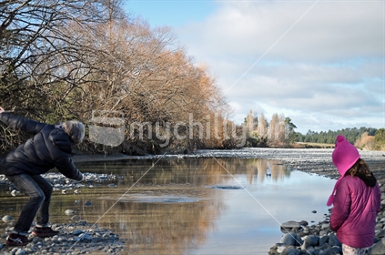 Skipping stones in the river (selective focus and motion blur)