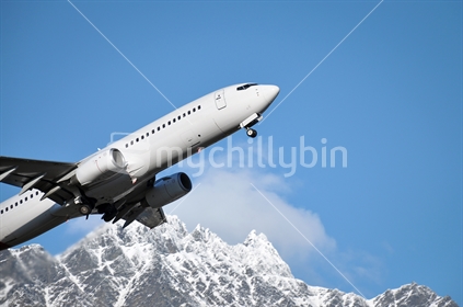 Take off at Queenstown with wheels in process of retracting.