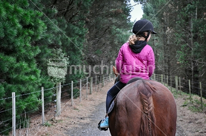 Girl riding a horse (selective focus and some motion blur)