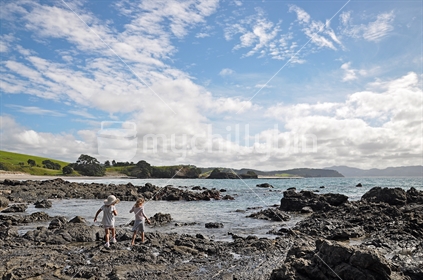 Young girls explore rockpools