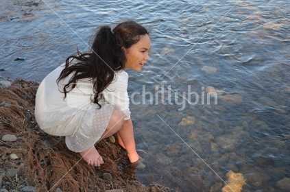 Maori girl enjoying the river. 