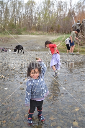 Maori children playing at a river.