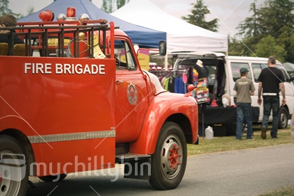 Vintage fire truck takes kids for a ride at the Kirwee show.