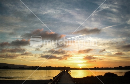 Sunset over the Avon Heathcote Estuary and pier in Christchurch, Canterbury, New Zealand