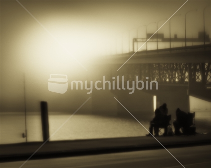 Fishing in the fog, under the Harbour Bridge, Auckland, New Zealand