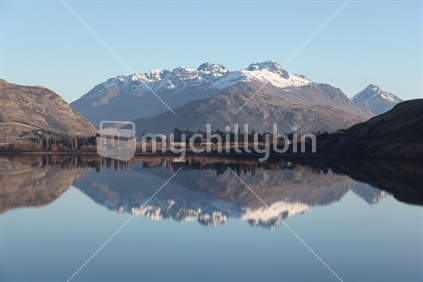 The Remarkables range reflected in Lake Hayes on a clear winter's day,  Queenstown