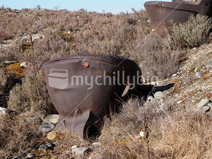 Old gold dredge buckets among thyme near Alexandra, Central Otago.