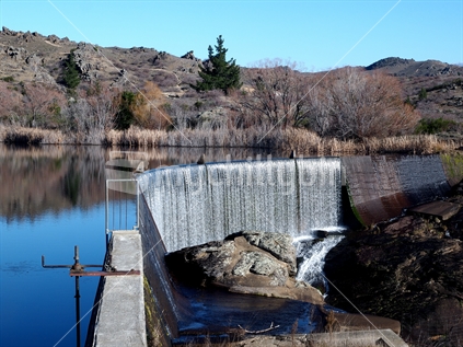 The Manorburn Dam lower basin and dam wall near Alexandra, New Zealand. Irrigation storage reservoir.
