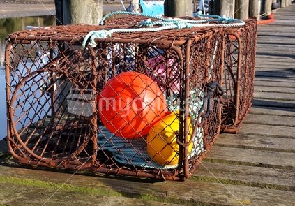 Cage on jetty with floats. 