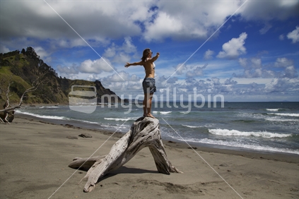 Woman salutes sky and beach