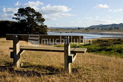Bench seat on a hill overlooking a bay