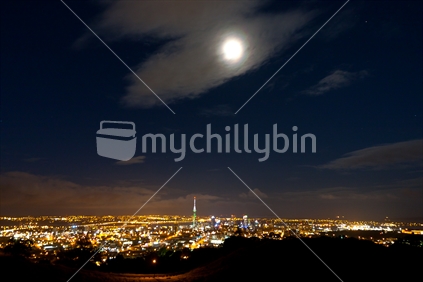 Full moon from Mt Eden, with blurred lights of Auckland below.