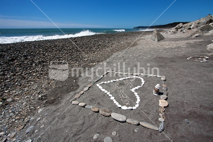 The symbols of love in beach sand. South Island, West Coast, New Zealand.