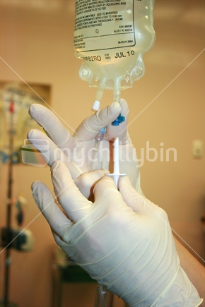 Preparing intravenous fluid for patient
