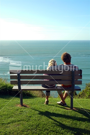 Couple on bench at sunset
